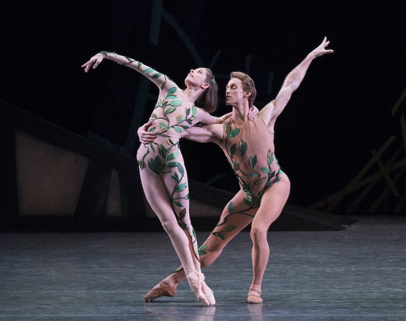 Dressed in nude unitards with green vines, Rebecca Krohn is en pointe while her partner Adrian Danchig-Waring holds her by the waist. She leans away from him